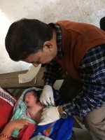 Examining newborn in a free health camp in outskirt of Kathmandu city